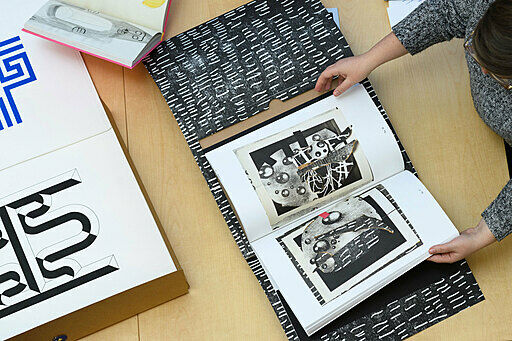 Looking at books on a table.