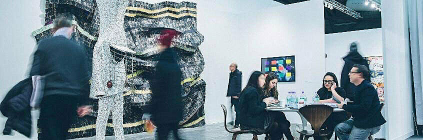 Visitors observe art at The Armory Show