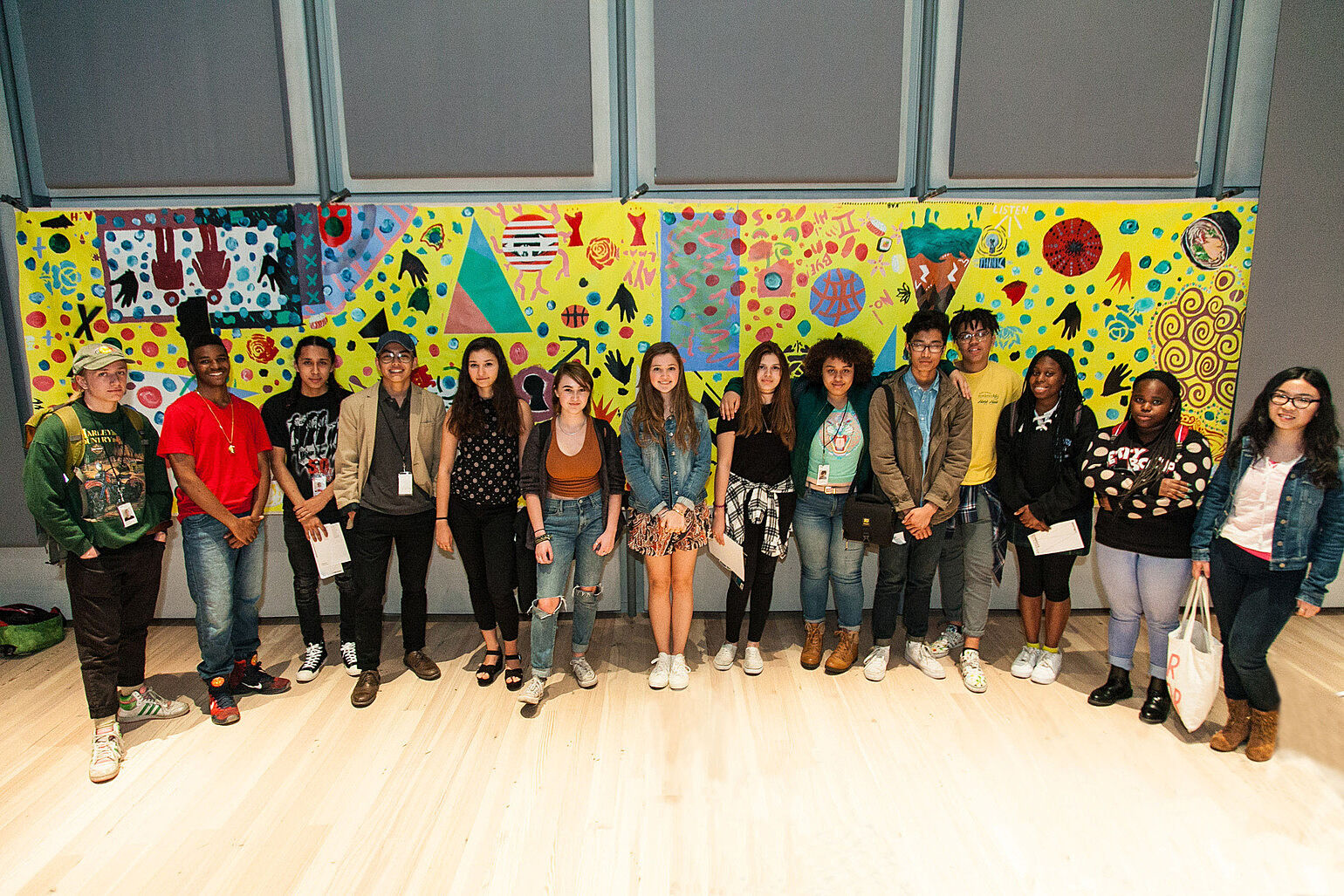 YI Artists pose with collaborative painting made with artist Nina Chanel Abney. Photograph by Andrew Kist.
