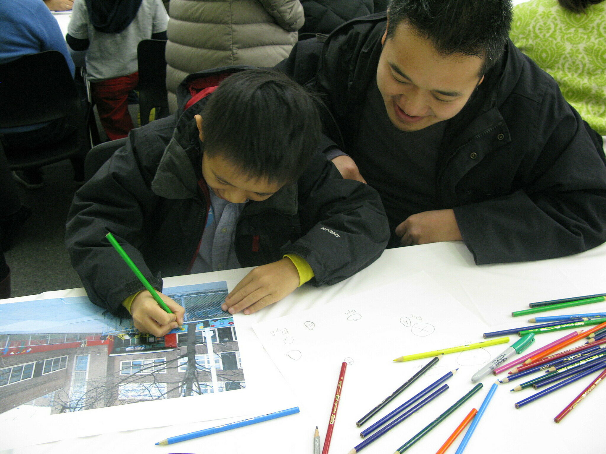 student and father working on artwork