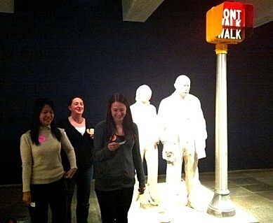 teachers standing next to statues