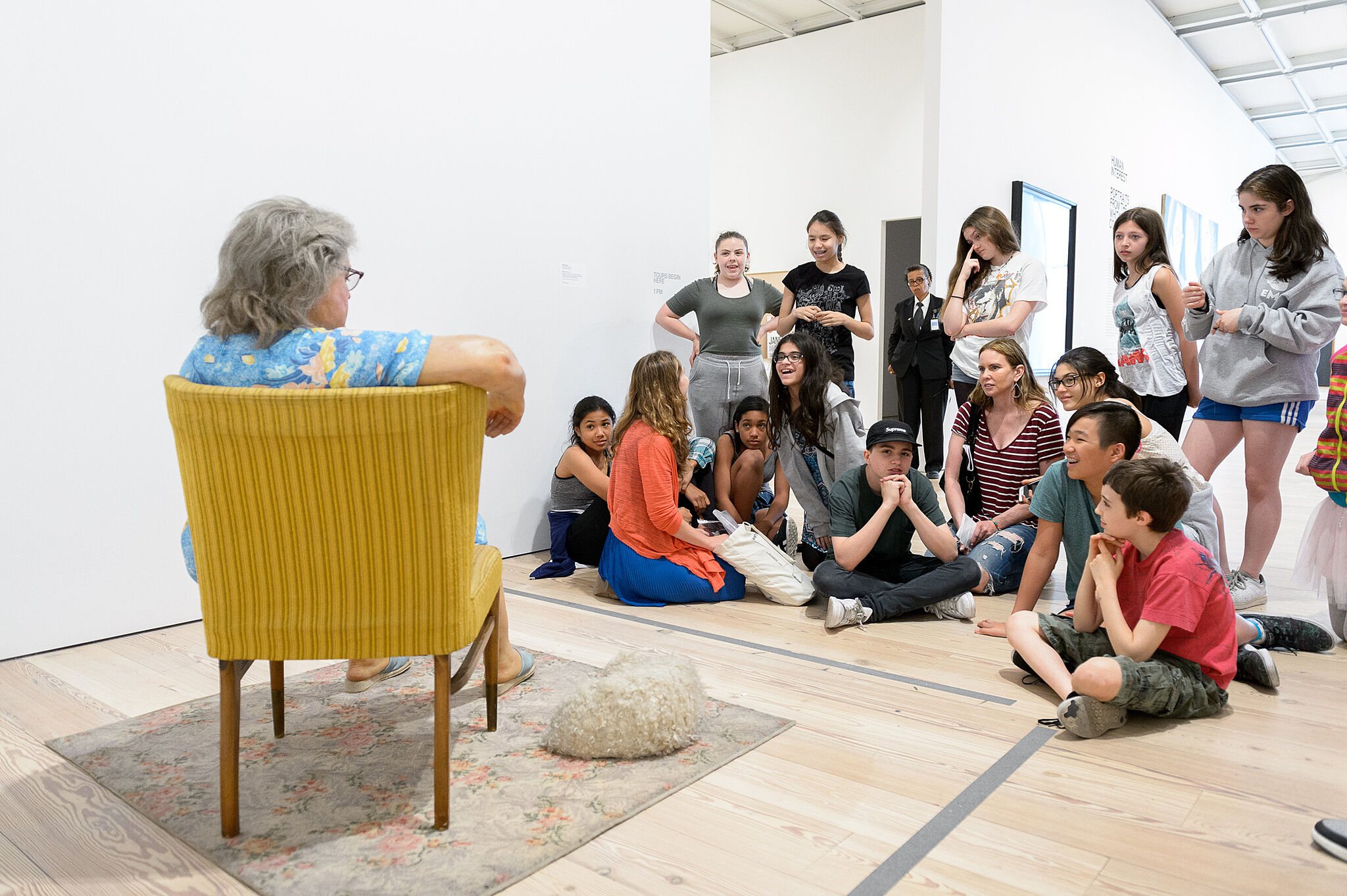 students sitting in front of sculpture