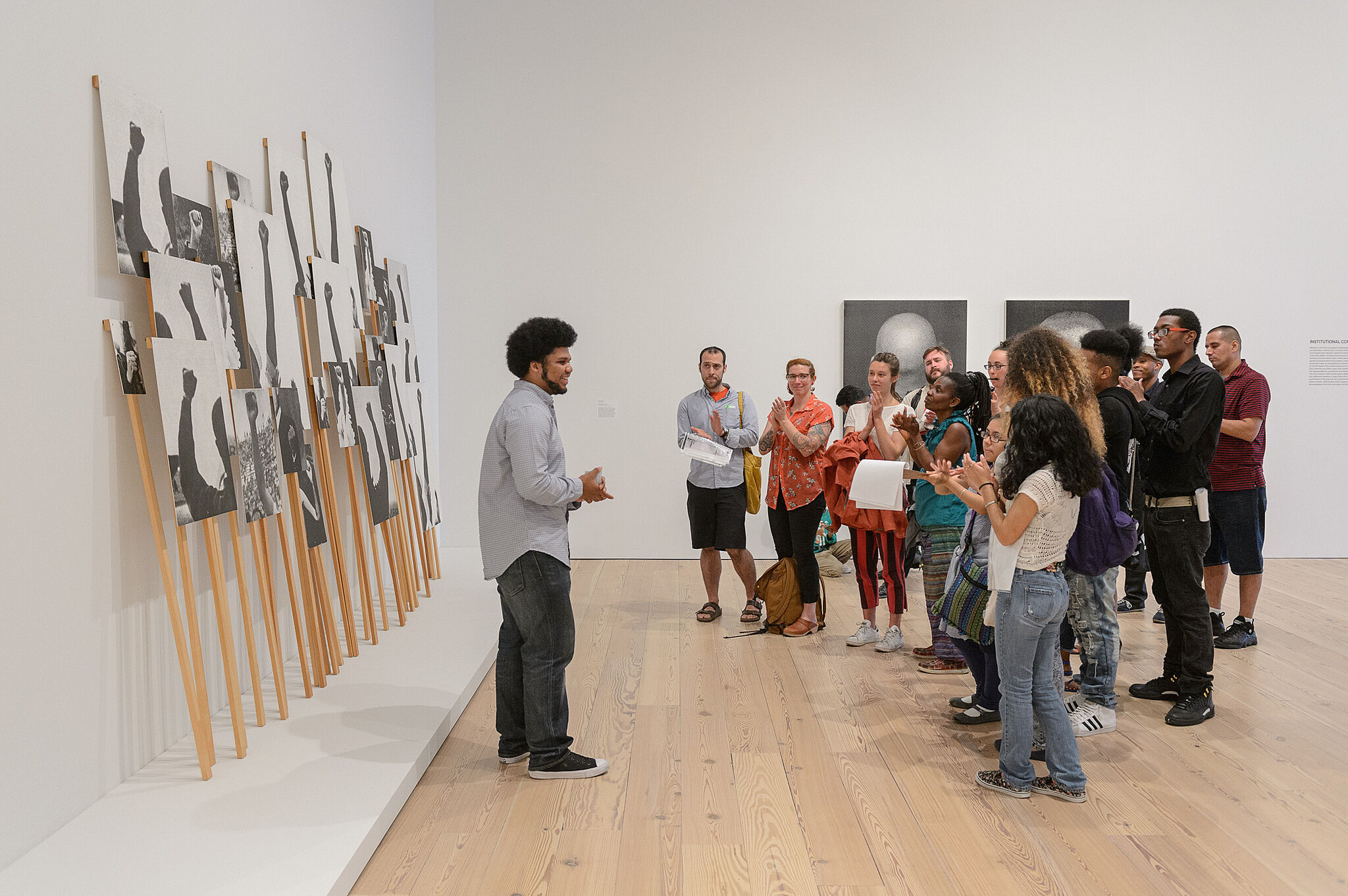 students and adults watch art and discuss