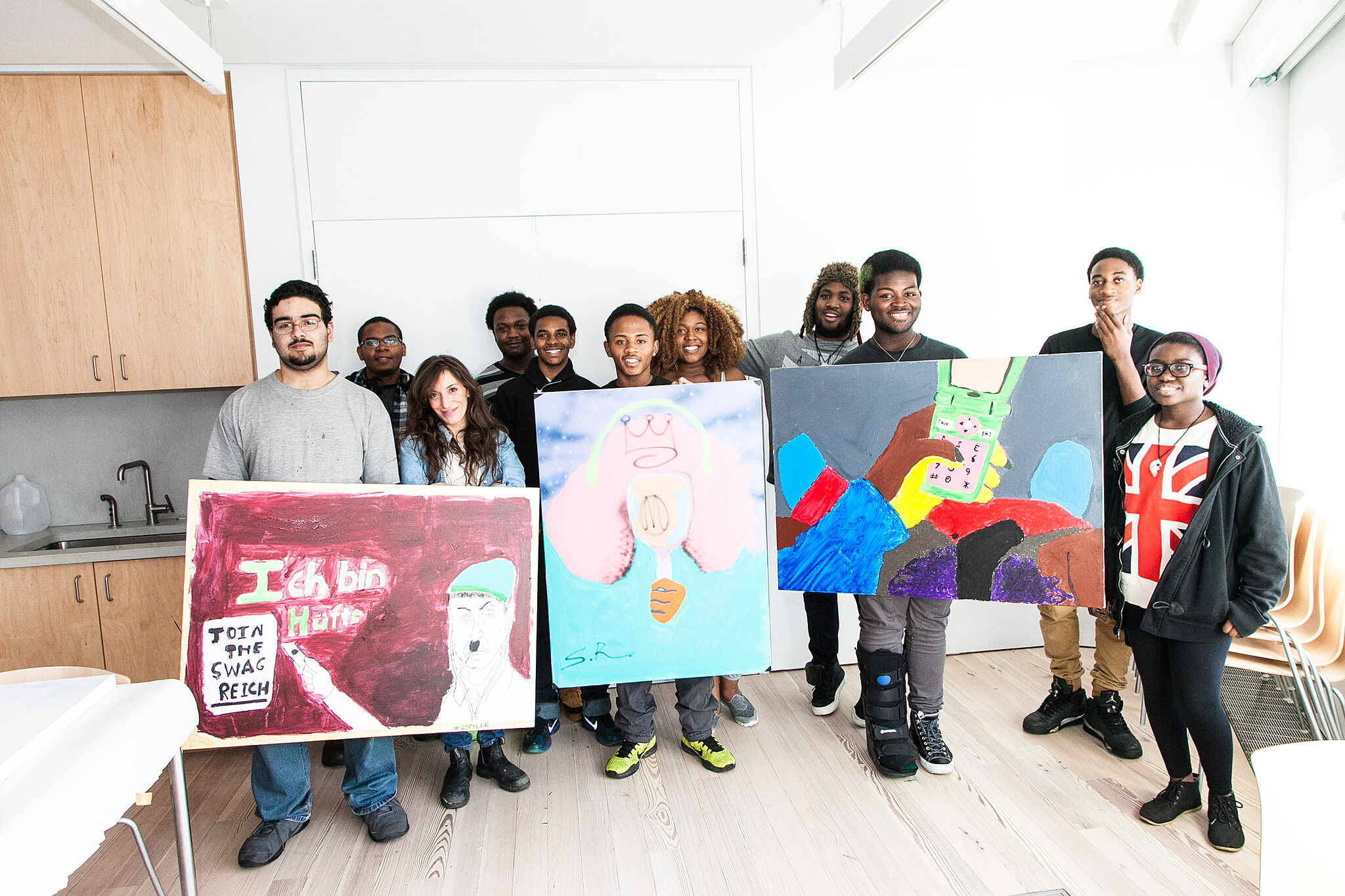 students holding up signs in room