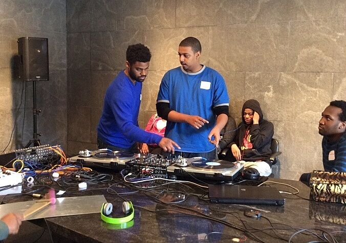 students working on a large black table on sound project