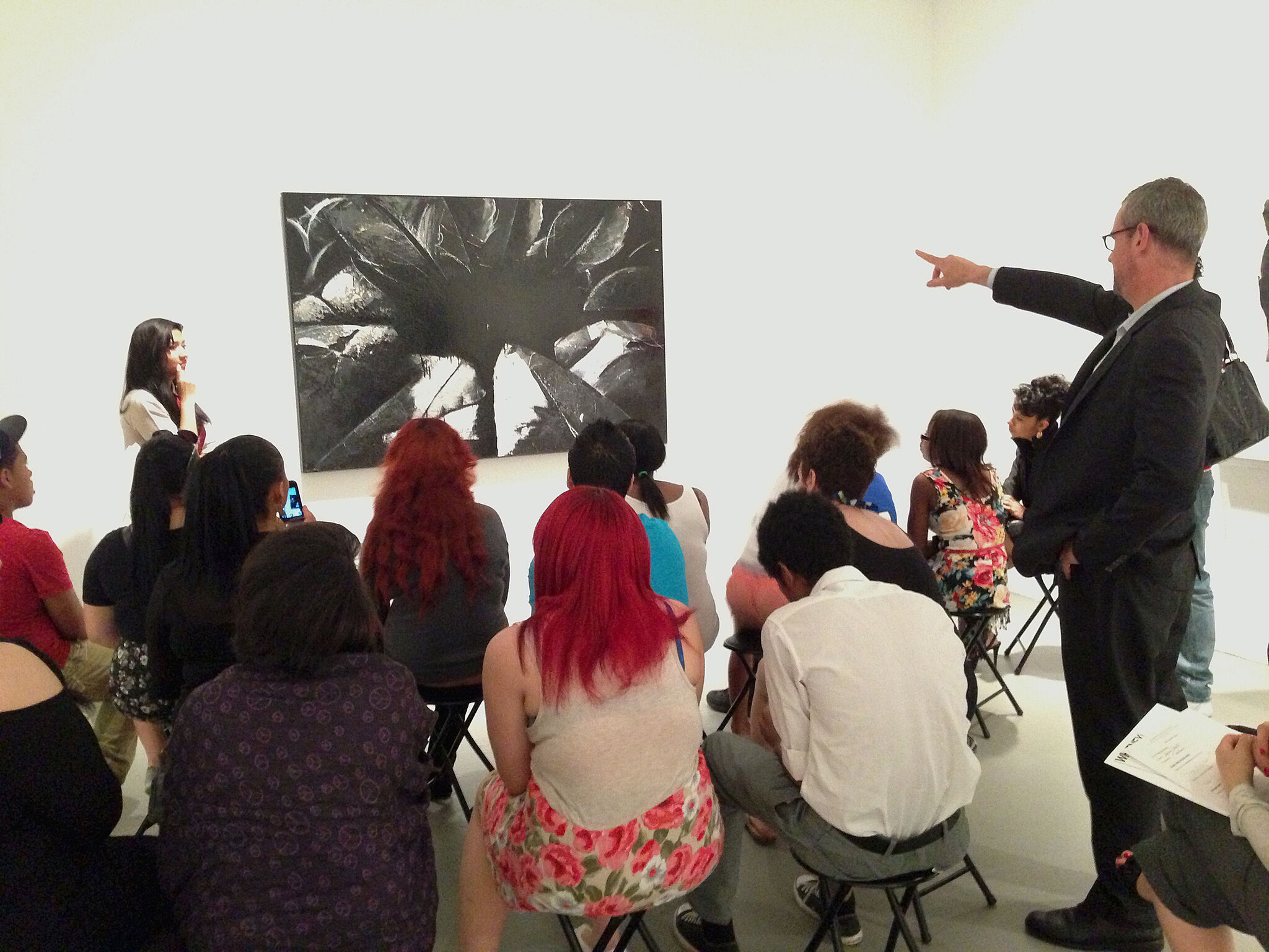 parents and teachers discussing artwork in gallery