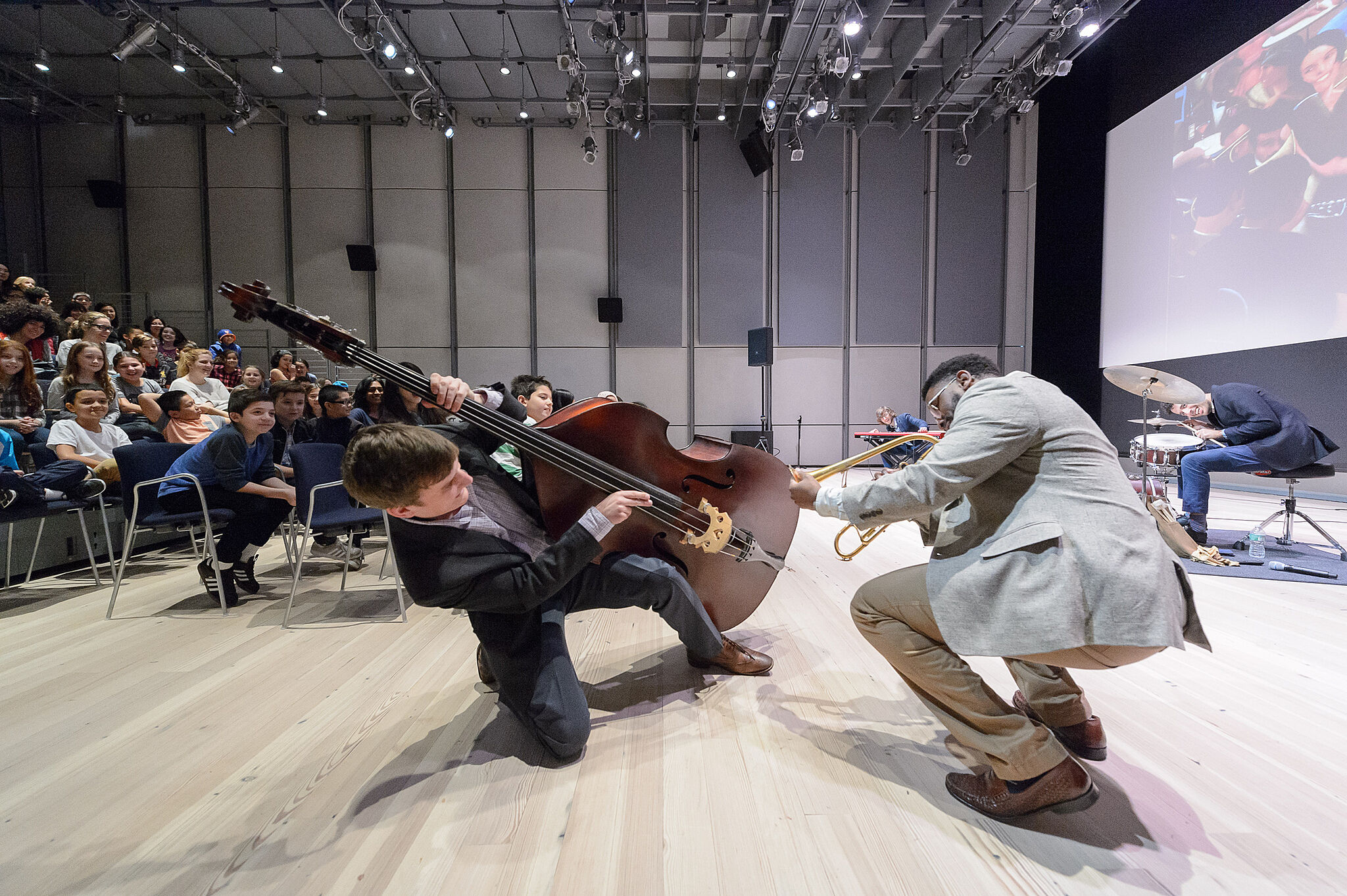 bass player and trumpet playing in funny position