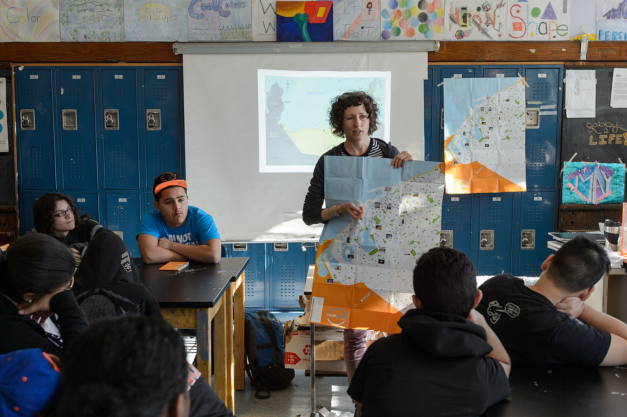 Artist presenting her map to class of students.