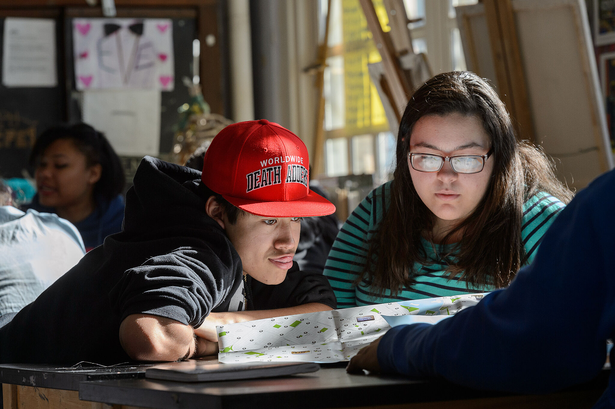 Two students peruse map together.