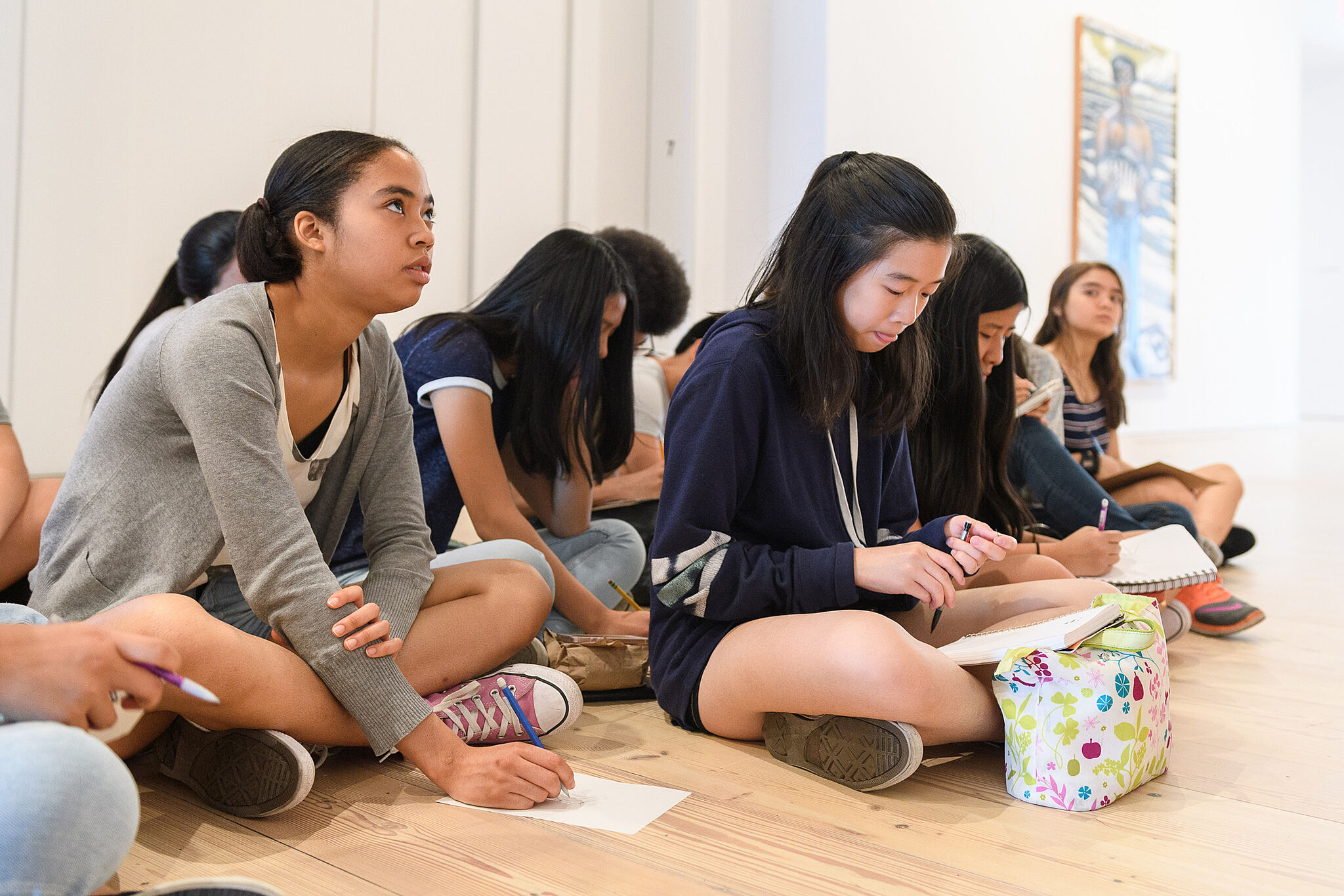 Students writing in notebooks.