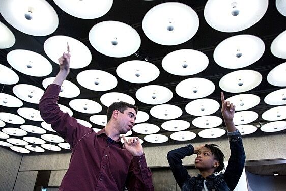 Artist and student pointing at installation.