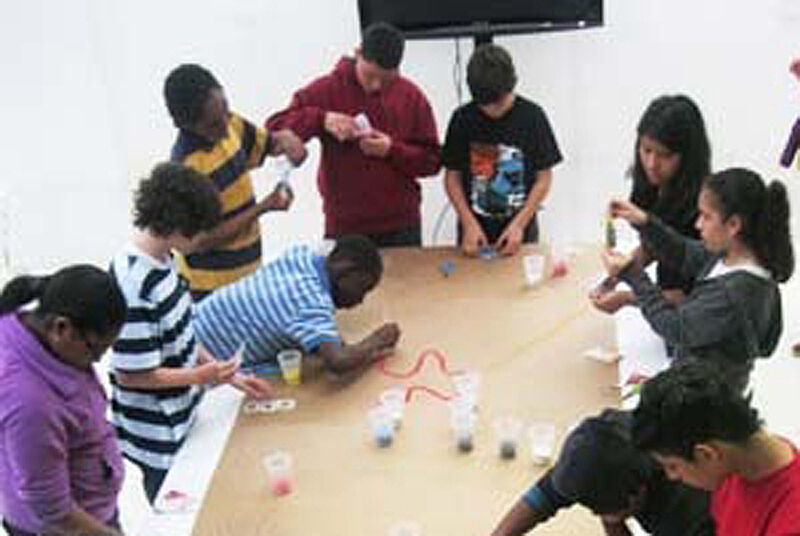 Students at table working on crafts.