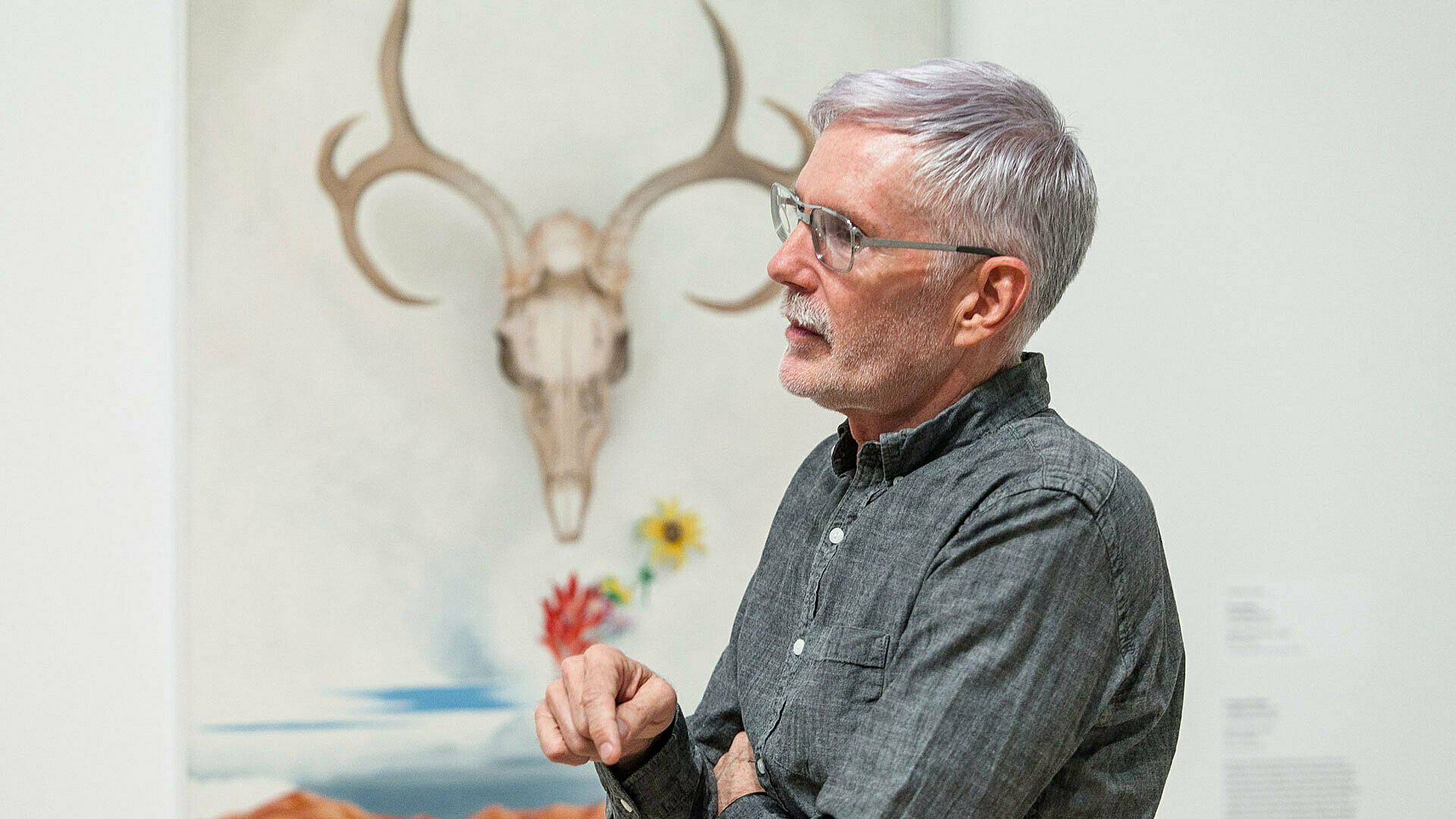 Buck talking in front of O'Keefe painting.