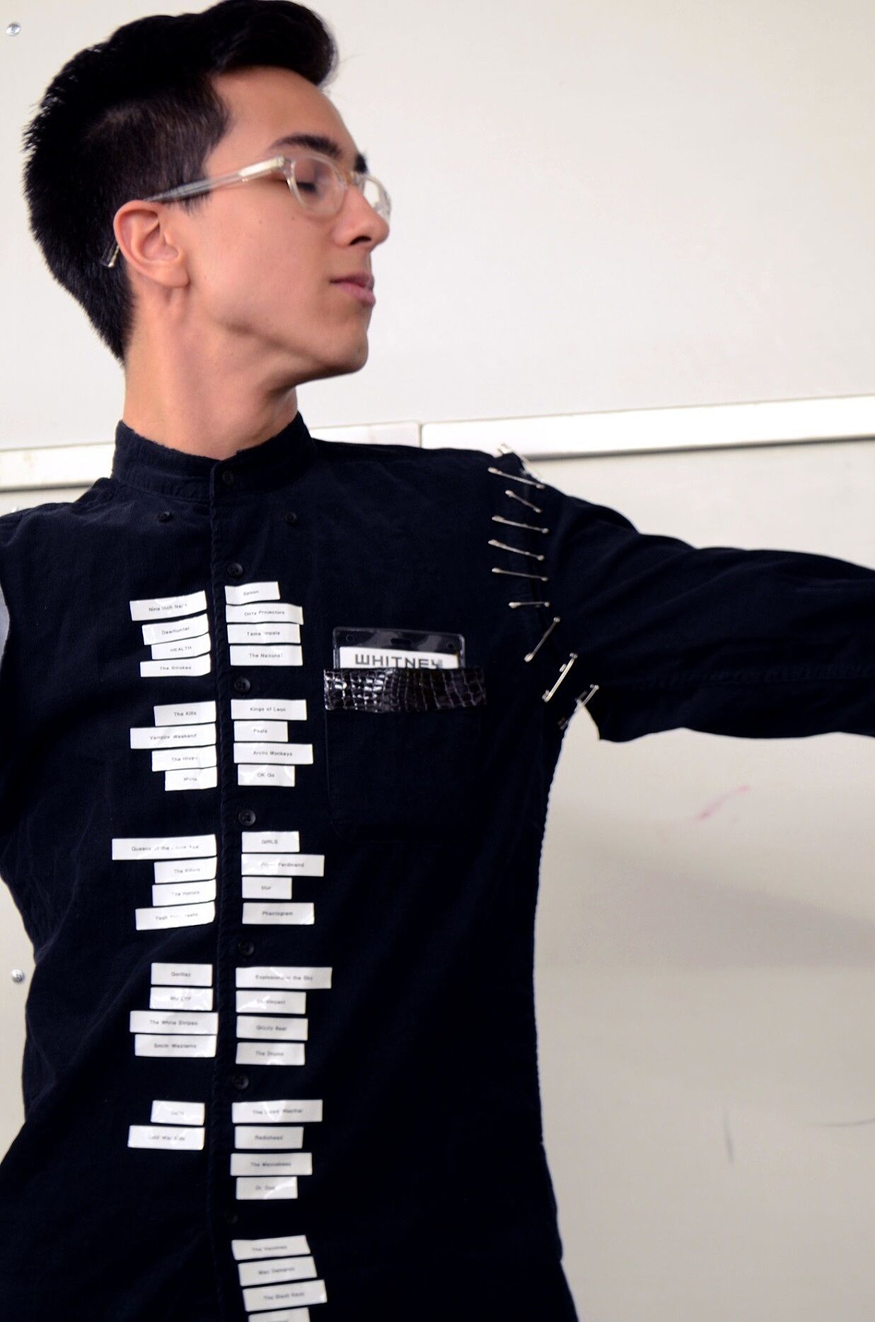 A student wears his costume that represents the Whitney Museum.