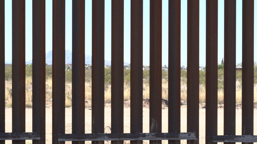 Video still of a brown fence.