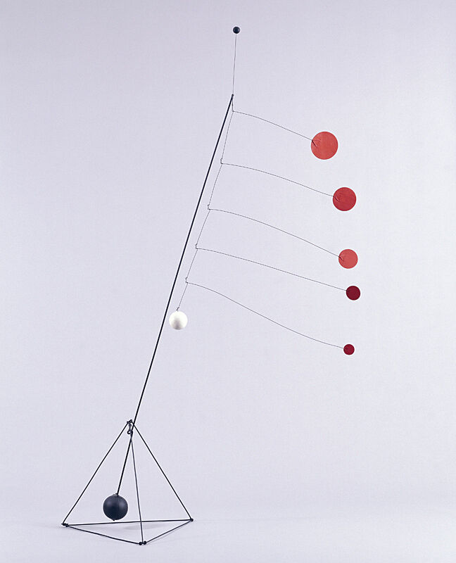 Steel sculpture with red circles attached to it by Alexander Calder.