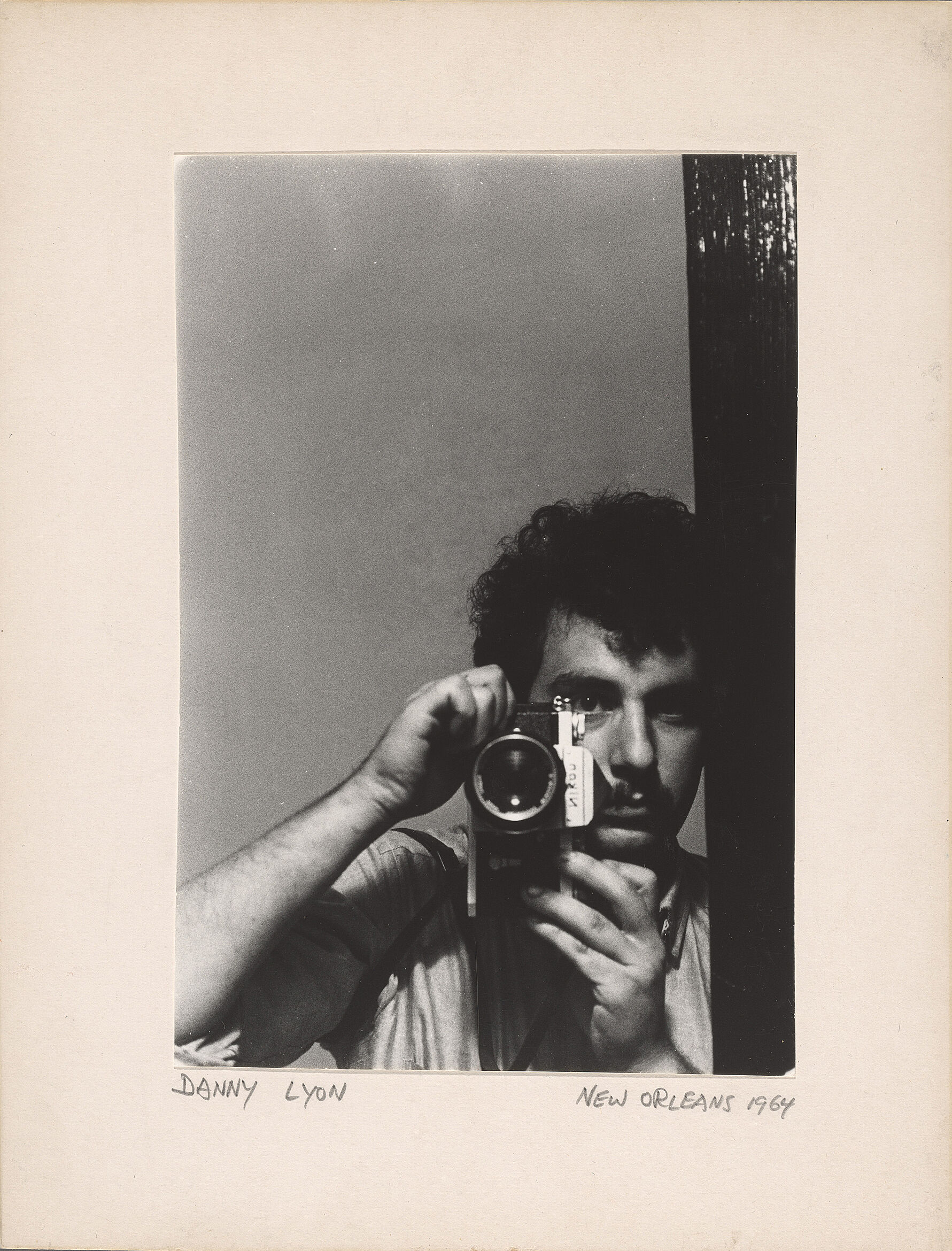 The artist Danny Lyon holds a camera for a self portrait.