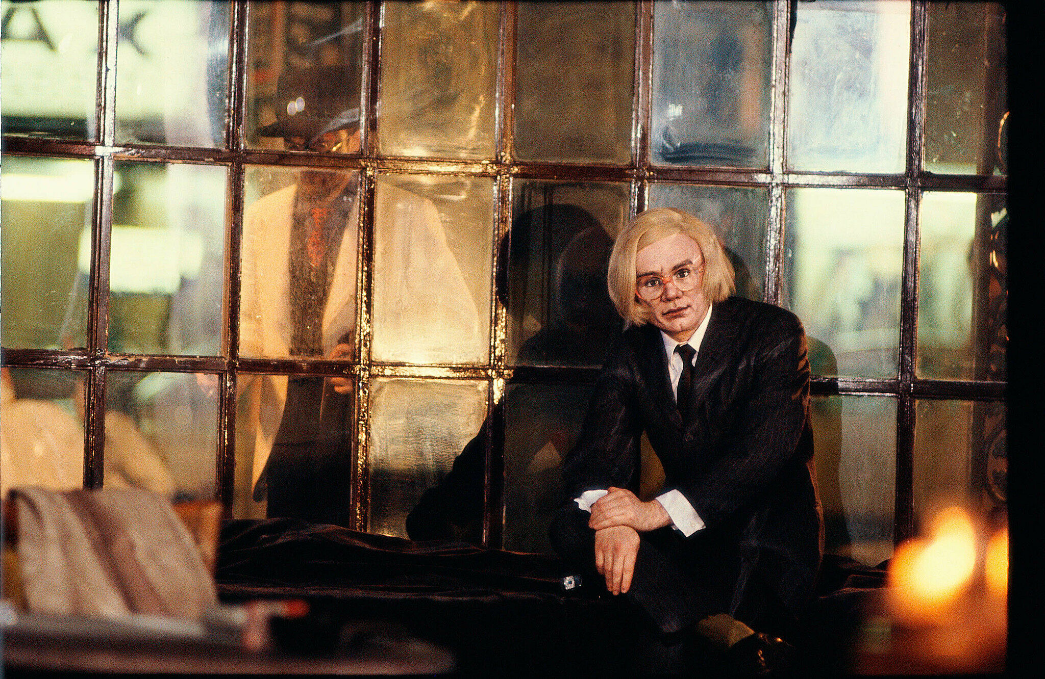 An artwork featuring Andy Warhol by the window.