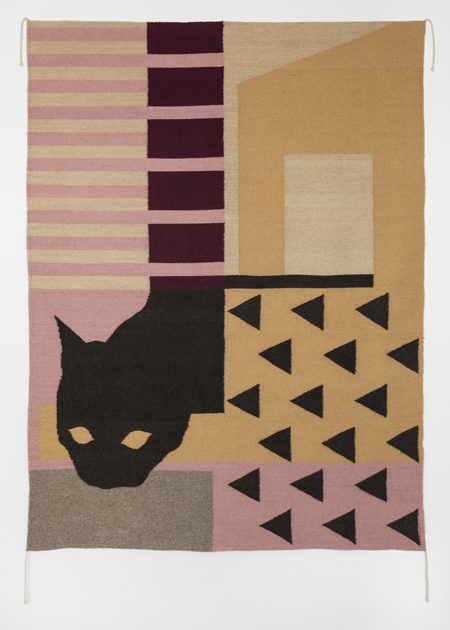 A woven textile with geometric shapes and the silhouette of a cat's head.