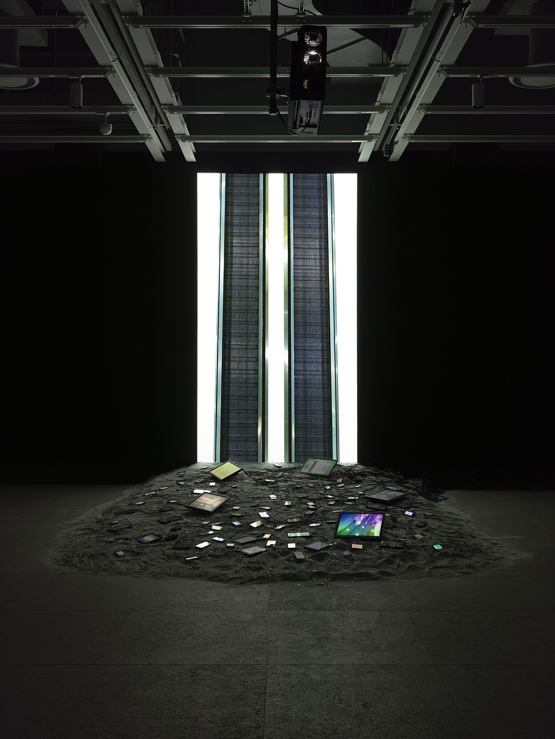 Video installation by Sophia Al-Maria in a darkened gallery.
