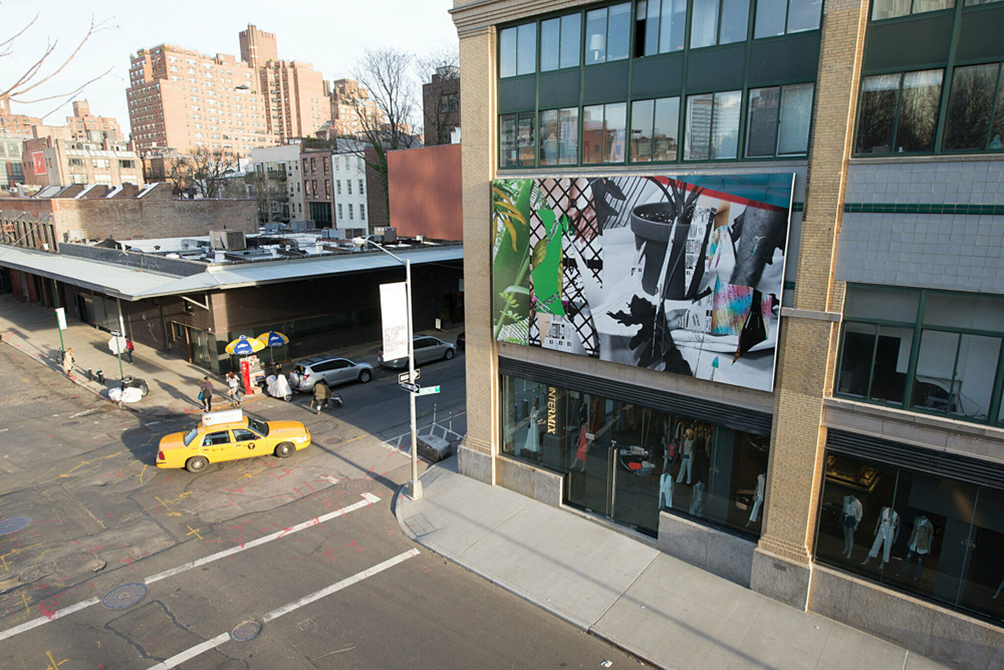 Image of people on highline gazing at installation on building across from the Whitney.