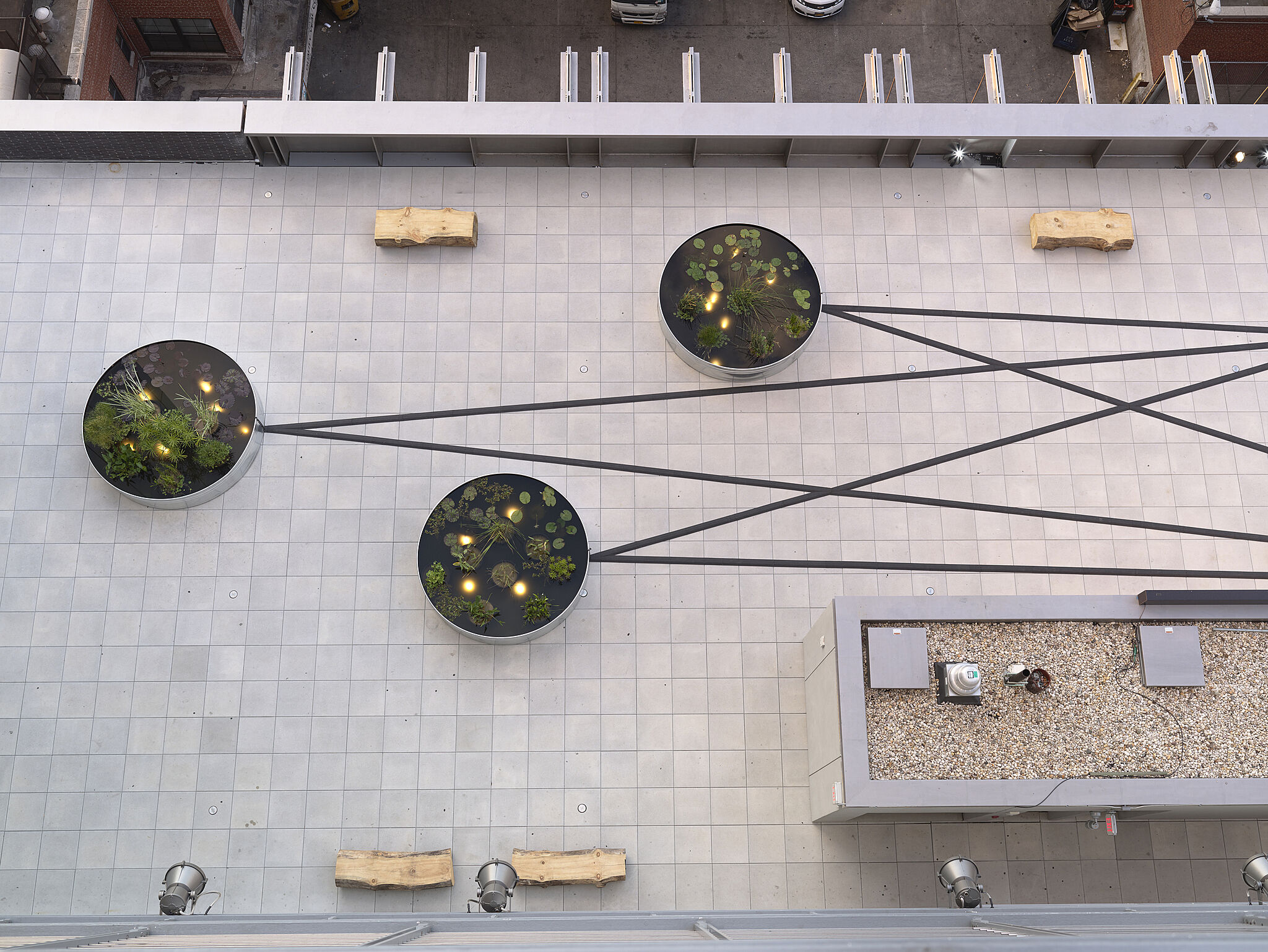 Looking down on three planters as part of an art installation on the Whitney Museum terrace.