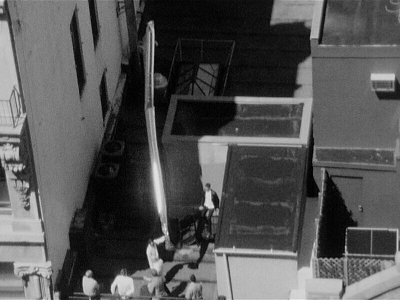 Black and white still of the top of a building.