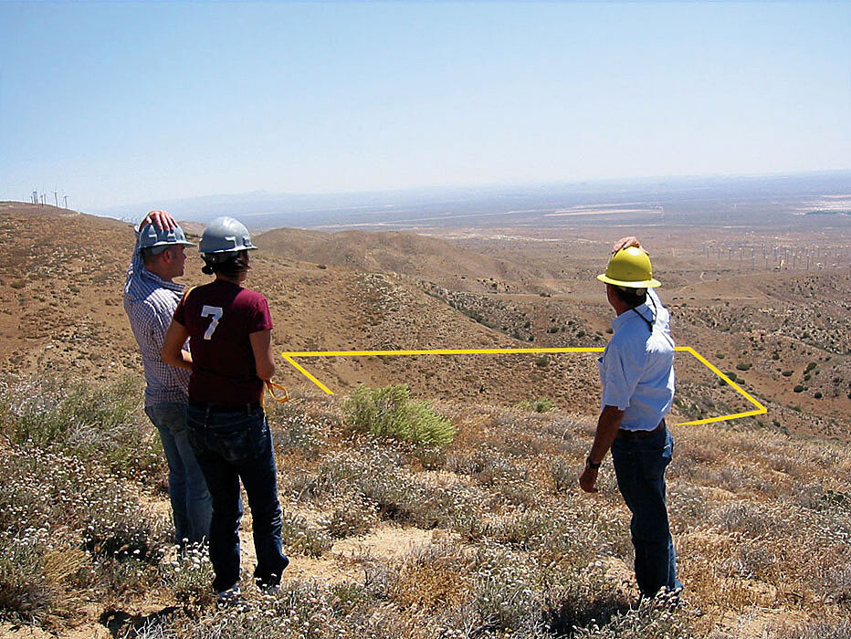 Surveyors looking out on desert.