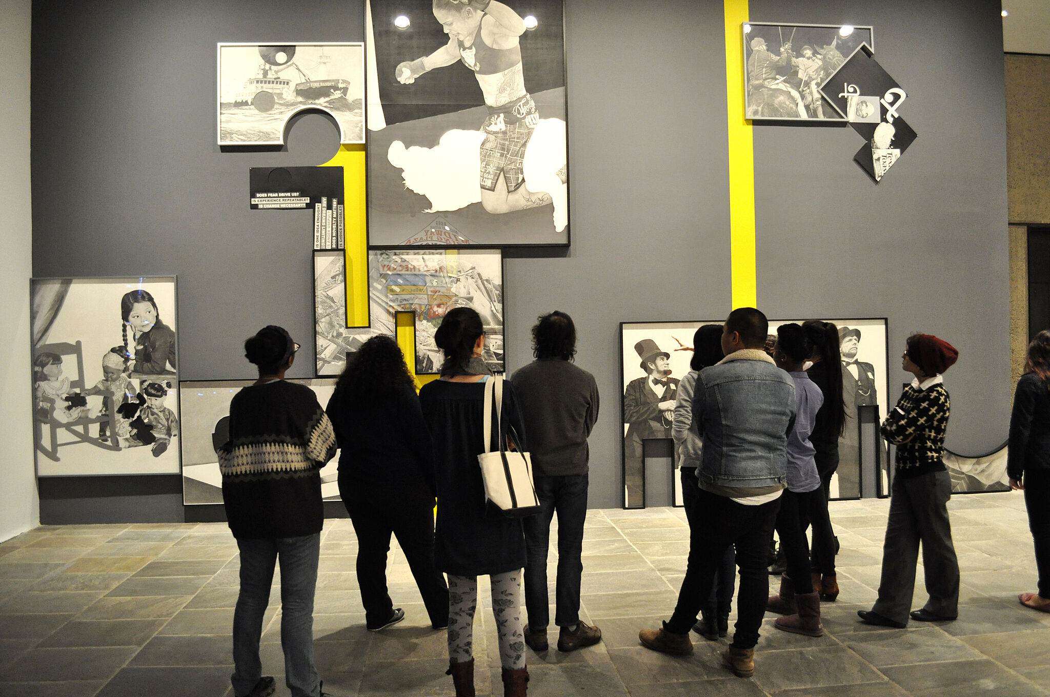 Students standing in a gallery space.