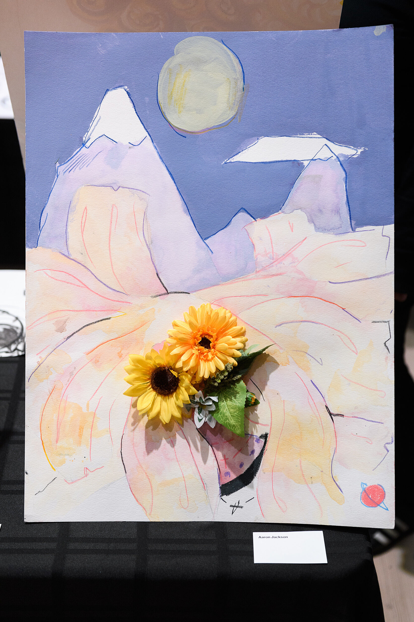 Mixed media of flowers and a landscape.