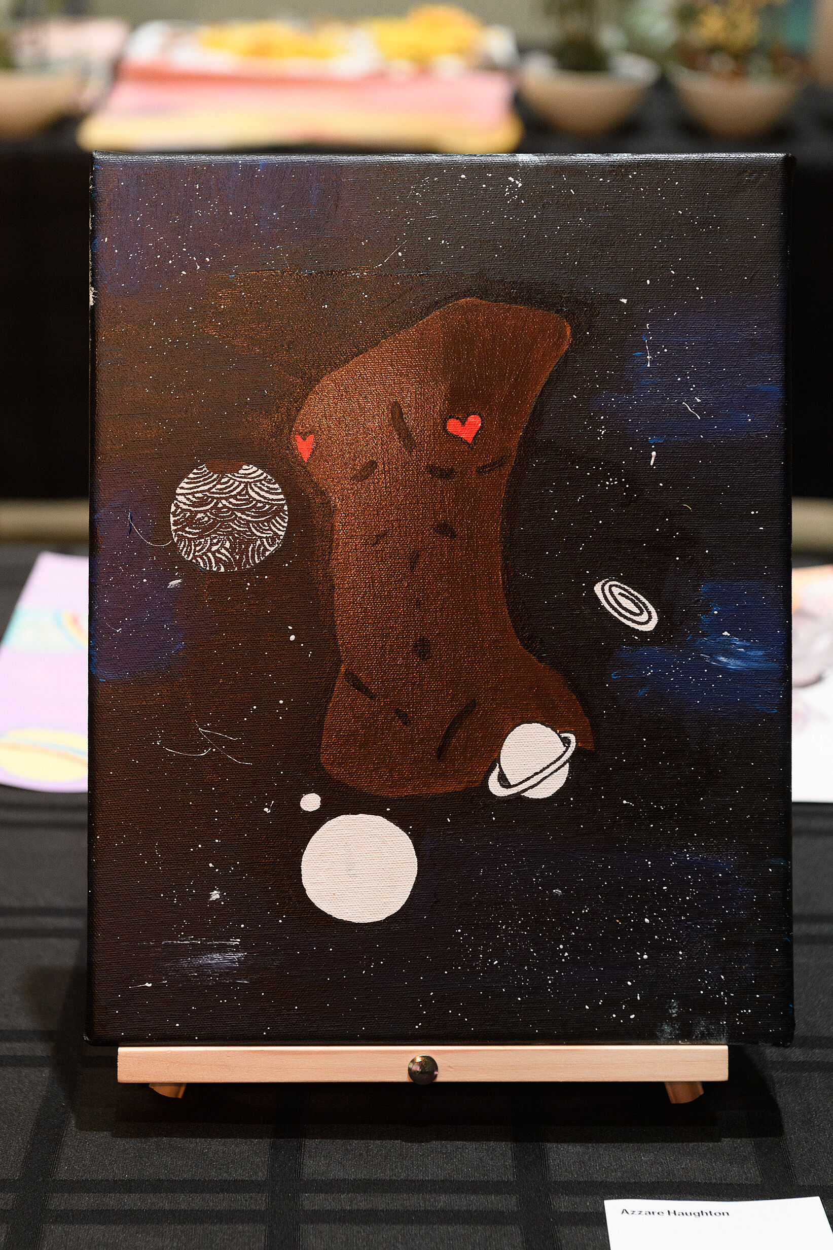 A torso painted in a space scene in dark colors.