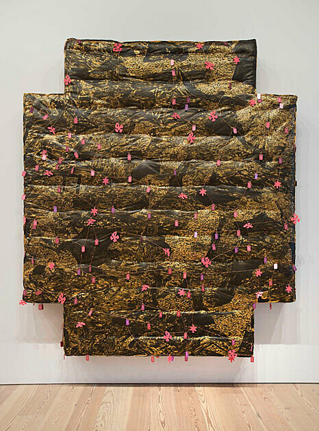 cross-shaped mattress covered in brown paint