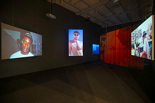 Videos projected in a dark room.