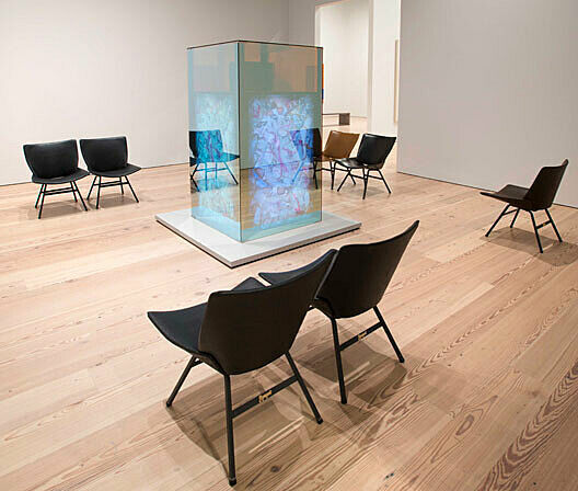 chairs seated around a glass rectangle structure
