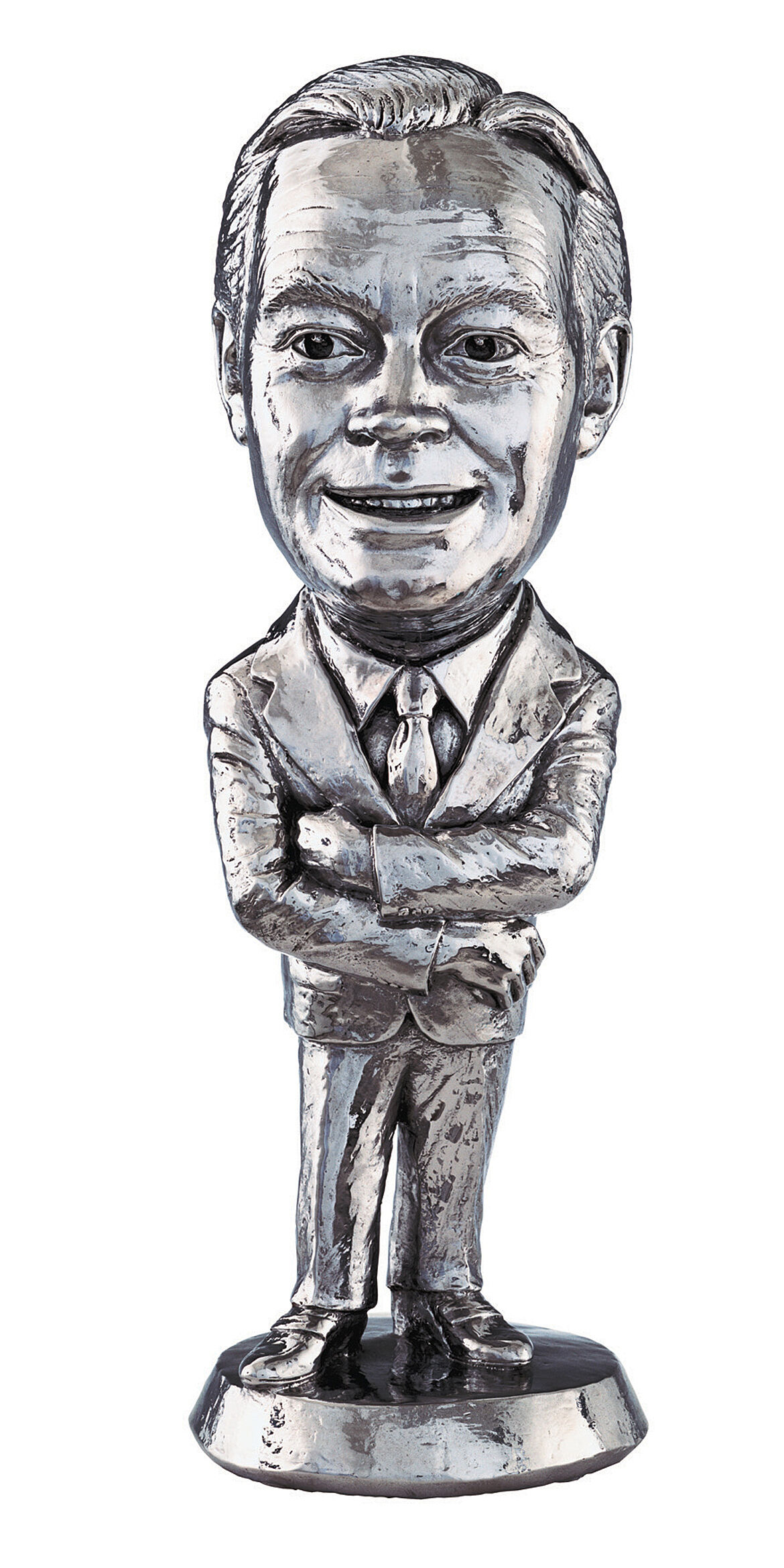 Metal caricature statue of a smiling man in a suit with crossed arms.