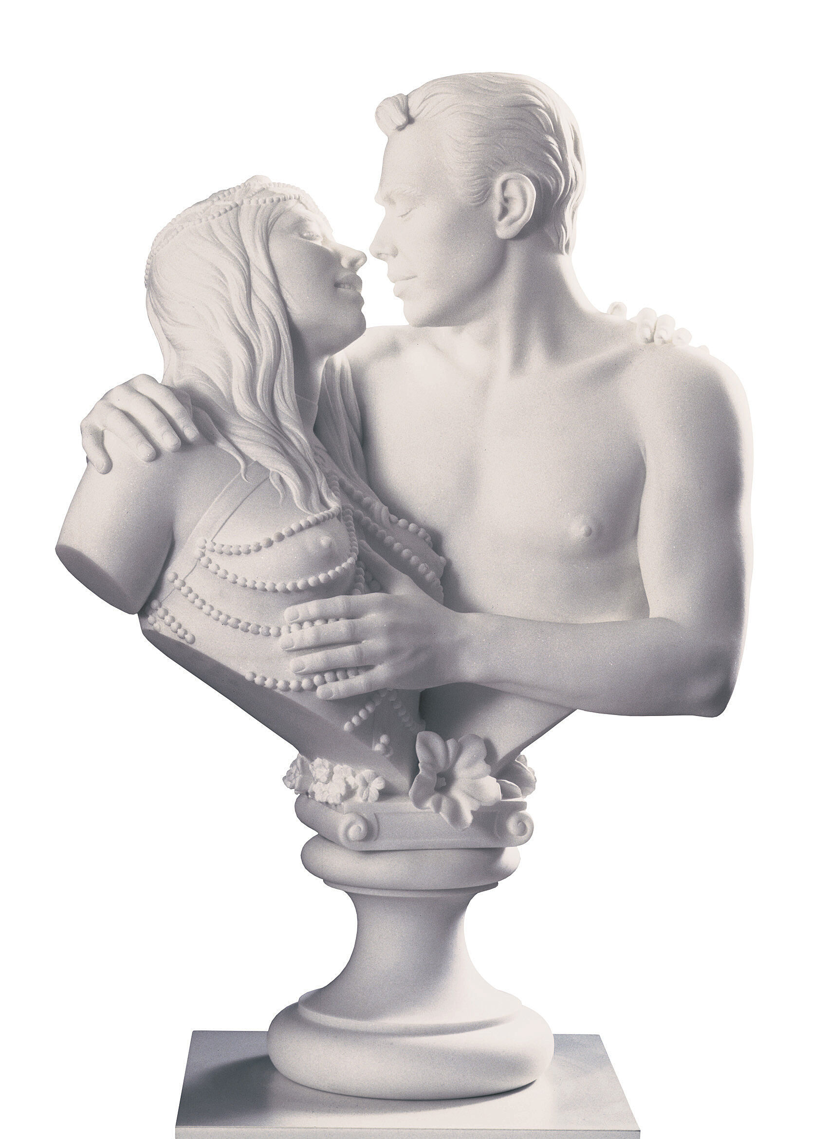 A marble sculpture of a man and woman embracing, with the woman adorned in beaded attire and the man shirtless, both gazing into each other's eyes.
