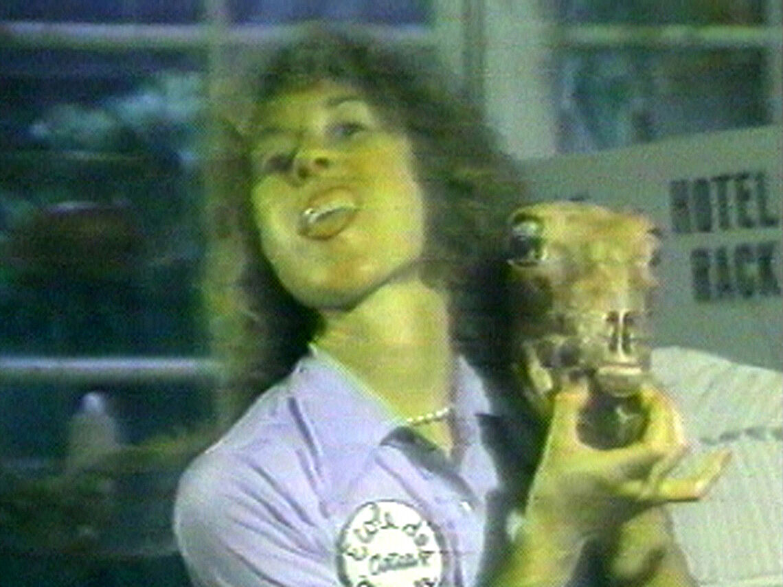 Film still of a woman holding a meat carcass.
