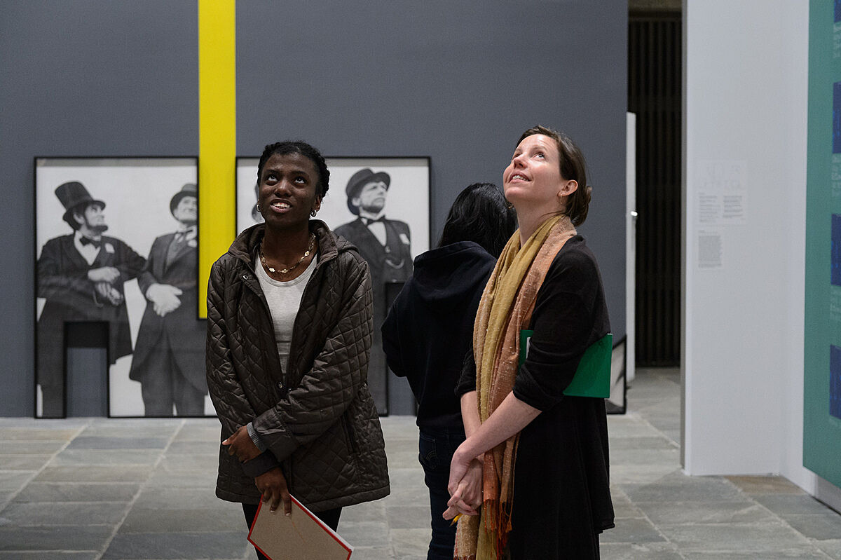 A writer and student looking at art in a gallery at the Whitney.