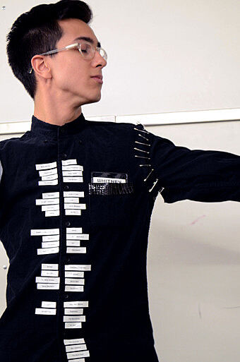 A teen artist wears text on black clothing.