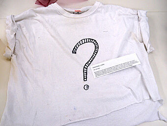 A white t-shirt with a question mark on it.