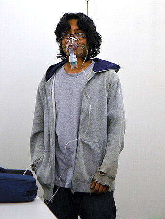 A teen artist wears an oxygen mask.