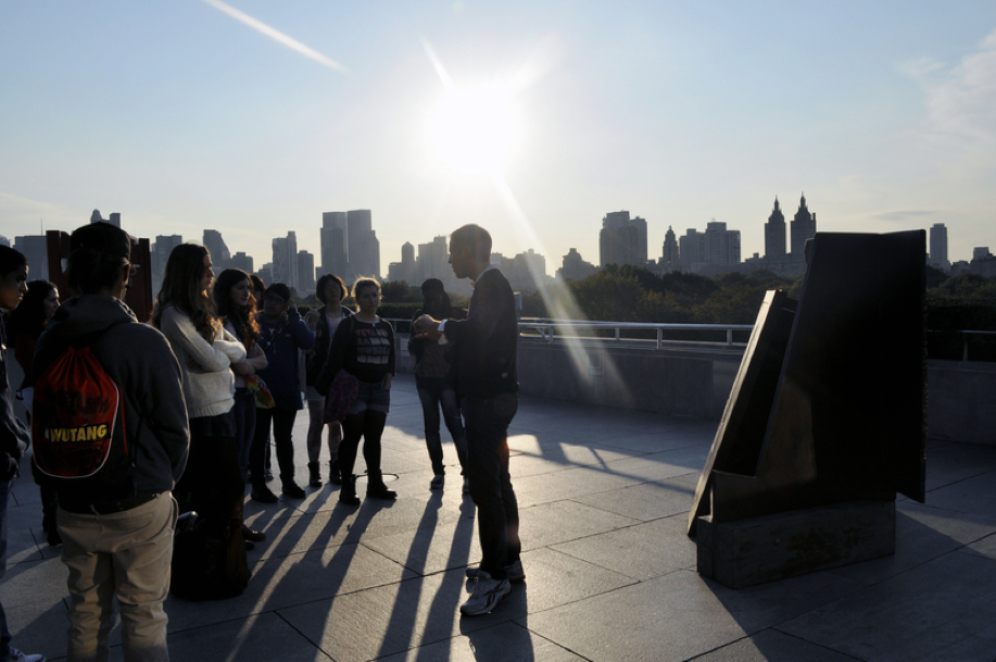 Artist Corey McCorkle with a group of students on the roof of the Met. 