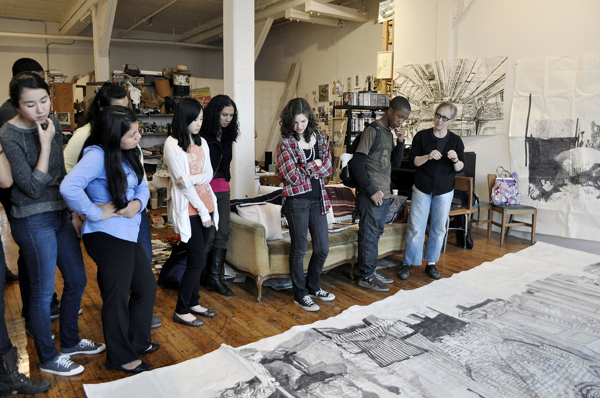 Artist Dawn Clements gather with a group of young writers.