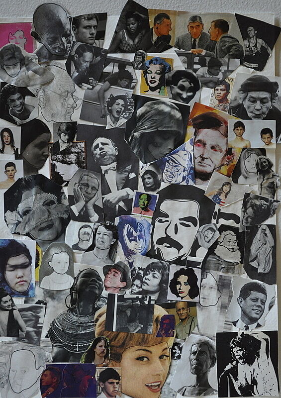 A collage of various black and white photo cutouts featuring dozens of faces and expressions pinned on a board.