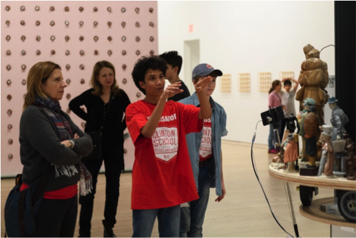 A Clinton student leads a discussion with his family and peers in the galleries