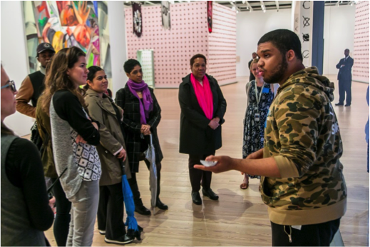 A Gotham student leads a discussion with his family and peers in the galleries