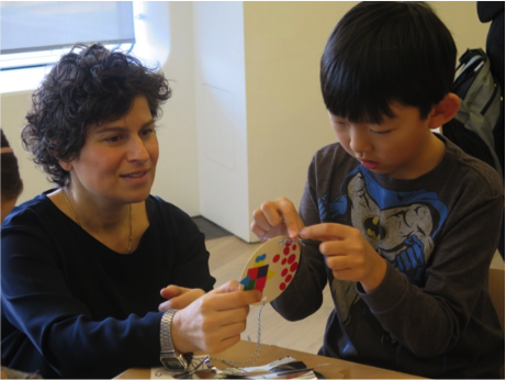 Artist Jenny Perlin works with student to make art