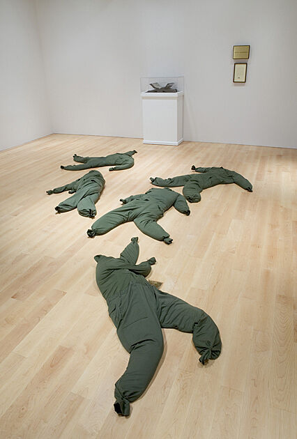 Army uniforms lying on the floor.