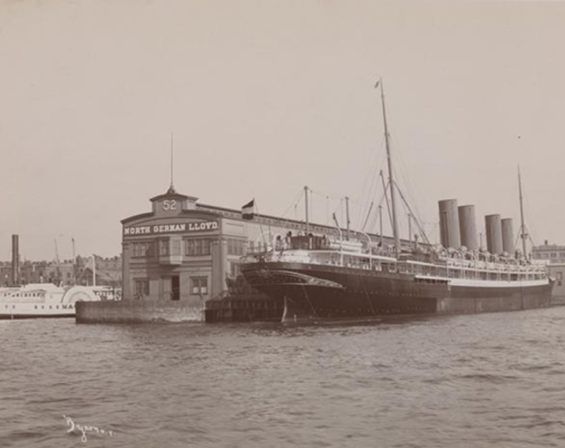 A sepia photo of a boat docked at a pier
