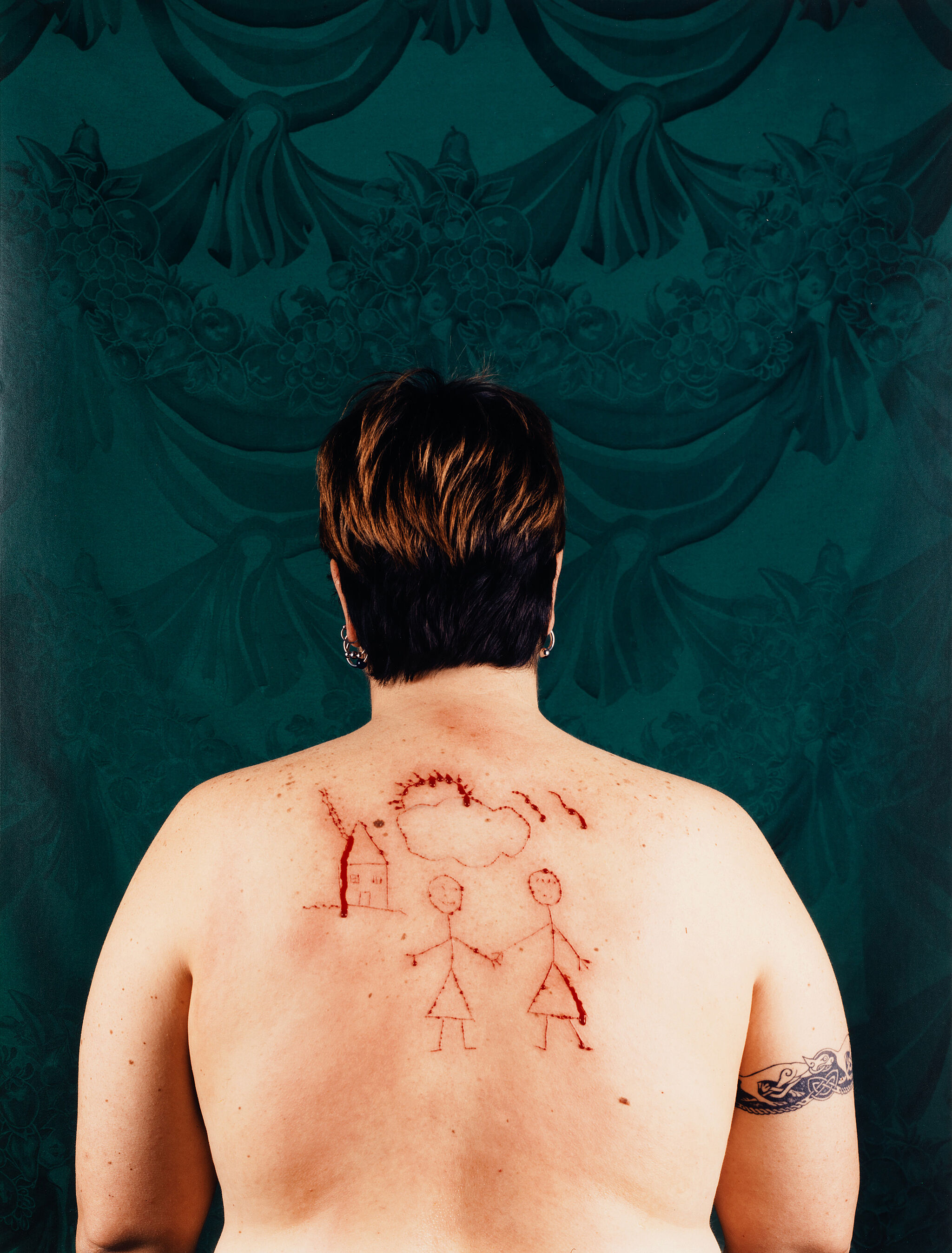 A woman's back with a drawing in blood.